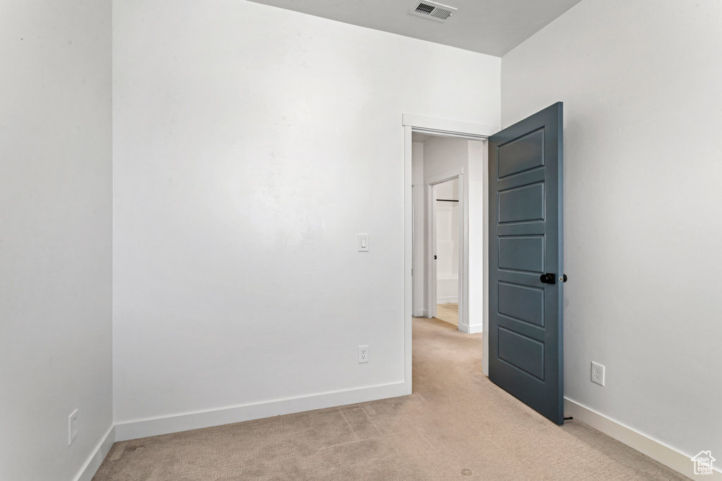 Spare room featuring light colored carpet