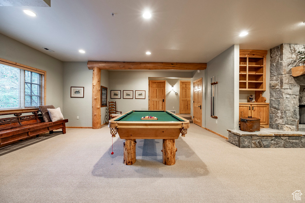 Recreation room with pool table, a fireplace, and light carpet