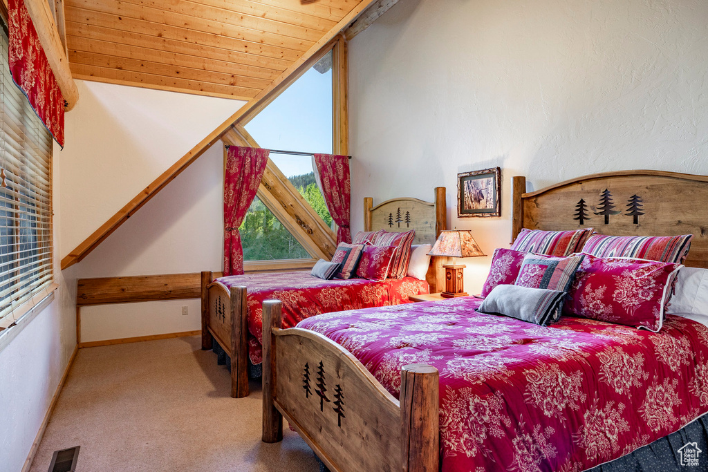 Carpeted bedroom featuring wooden ceiling