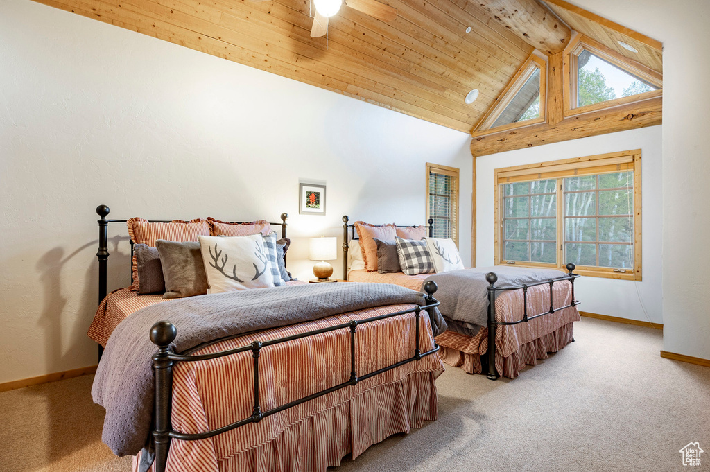 Carpeted bedroom featuring high vaulted ceiling, wooden ceiling, beam ceiling, and multiple windows