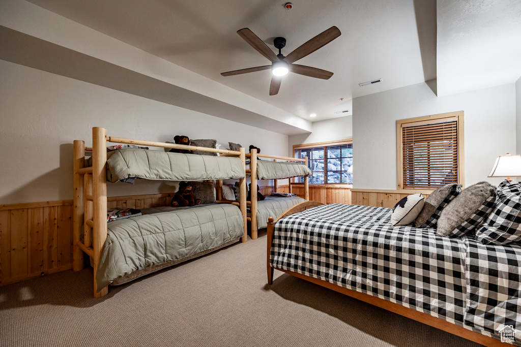 Carpeted bedroom with ceiling fan