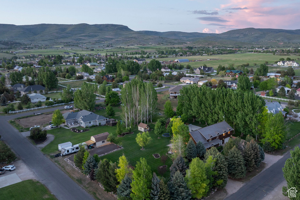 Aerial view of property and surrounding area featuring a mountain backdrop
