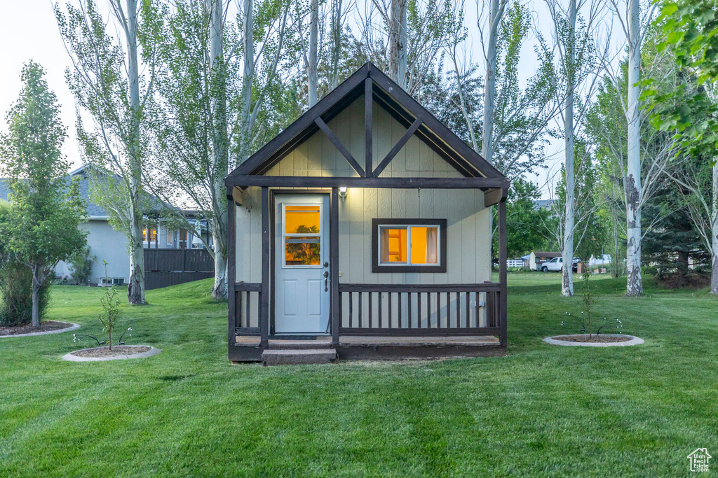 Rear view of house with a yard