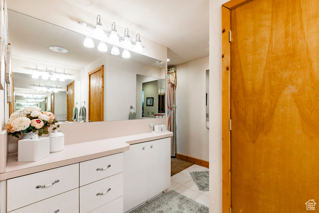 Bathroom featuring vanity and tile patterned flooring