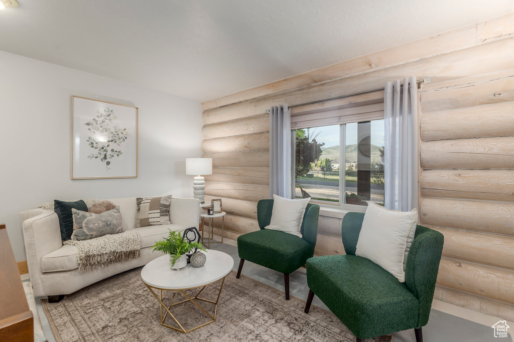 Living room featuring log walls