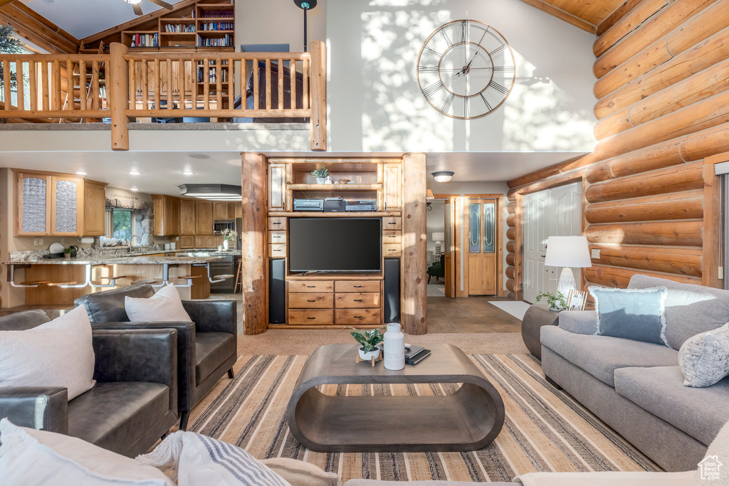 Living area with high vaulted ceiling and rustic walls