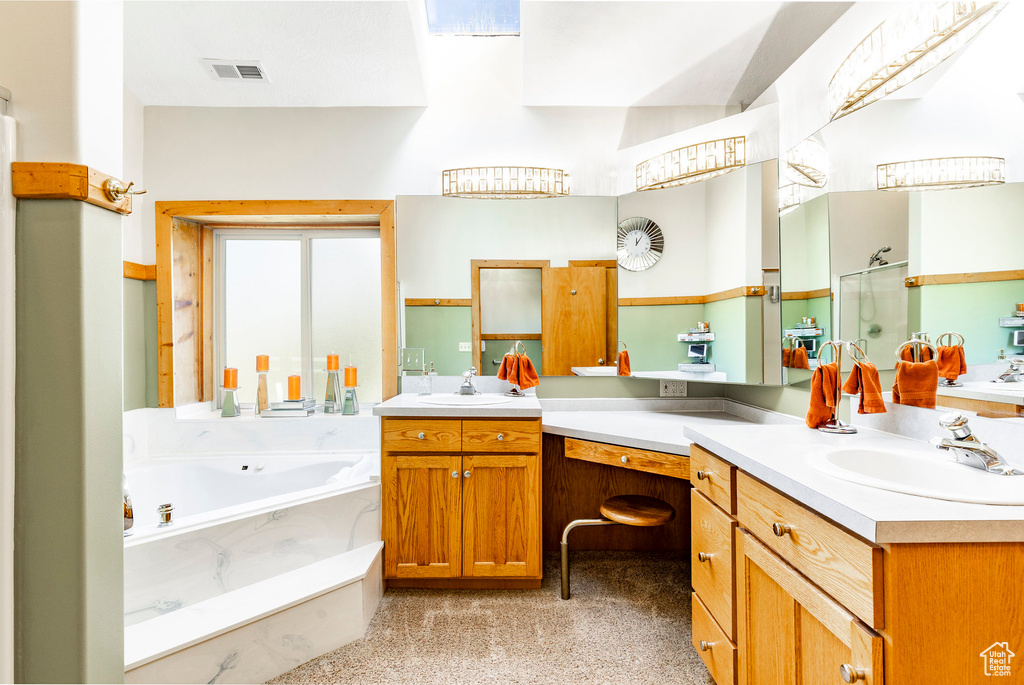 Full bath featuring vanity, a garden tub, and a shower stall