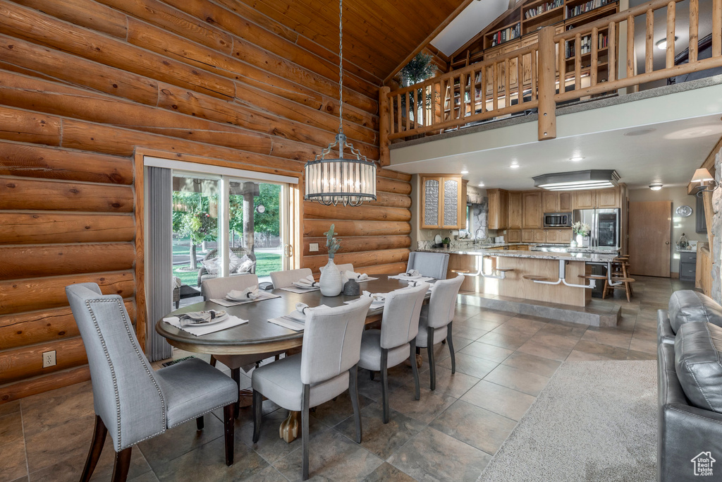 Dining space featuring a chandelier, wood ceiling, and high vaulted ceiling