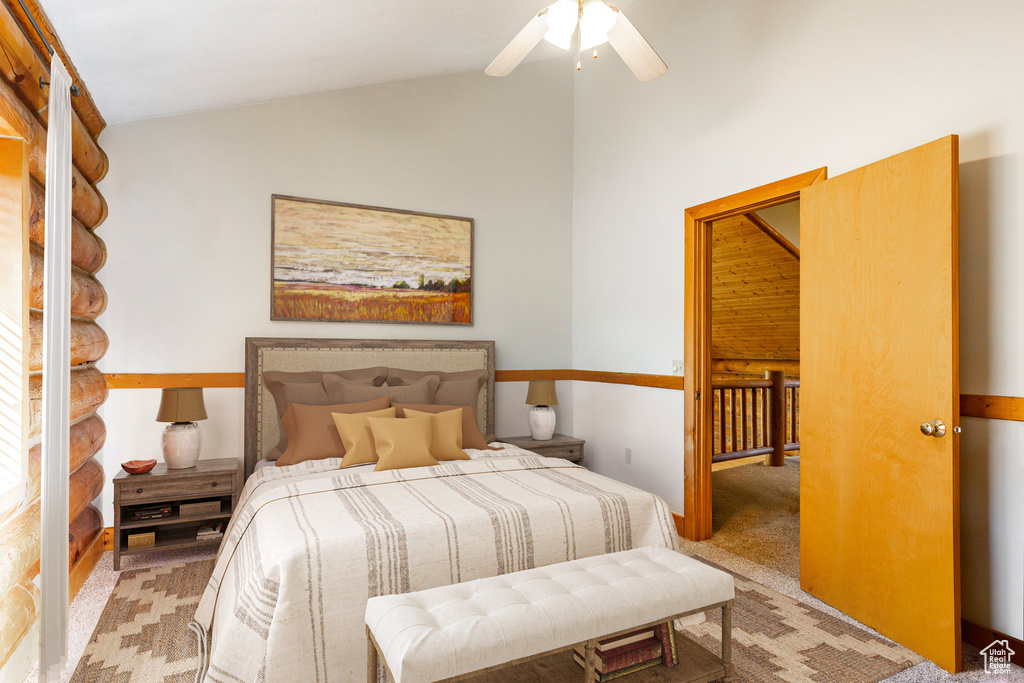 Bedroom with lofted ceiling, light carpet, and a ceiling fan