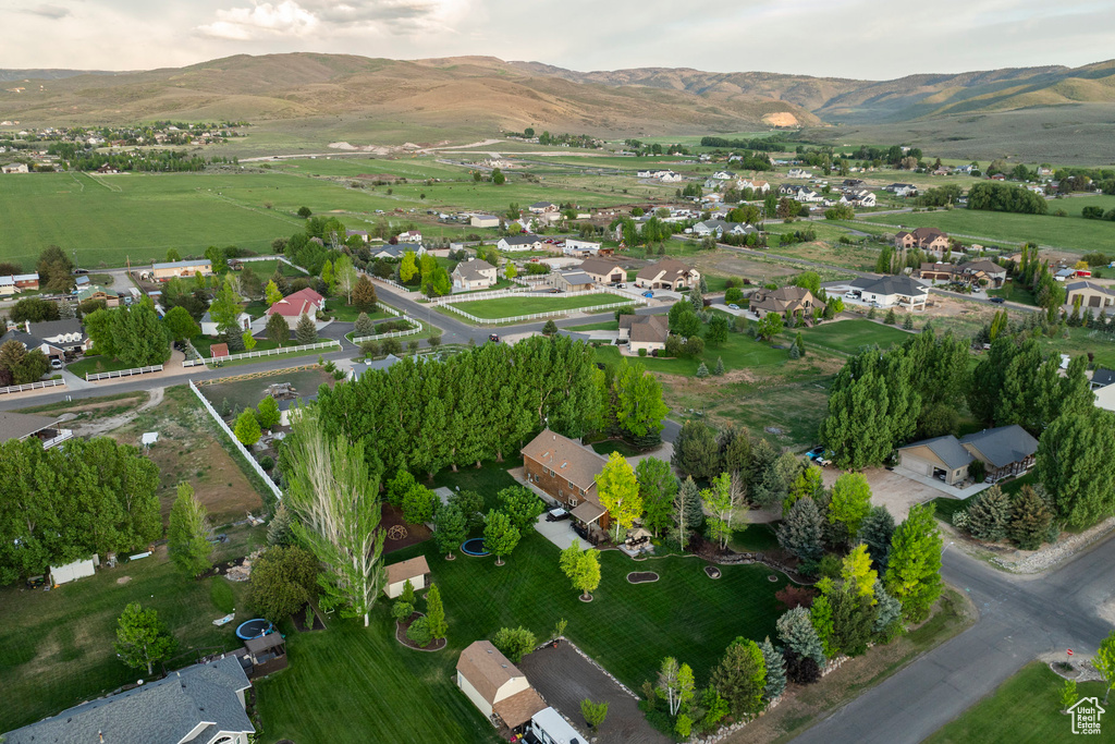 Aerial overview of property\'s location featuring mountains and nearby suburban area