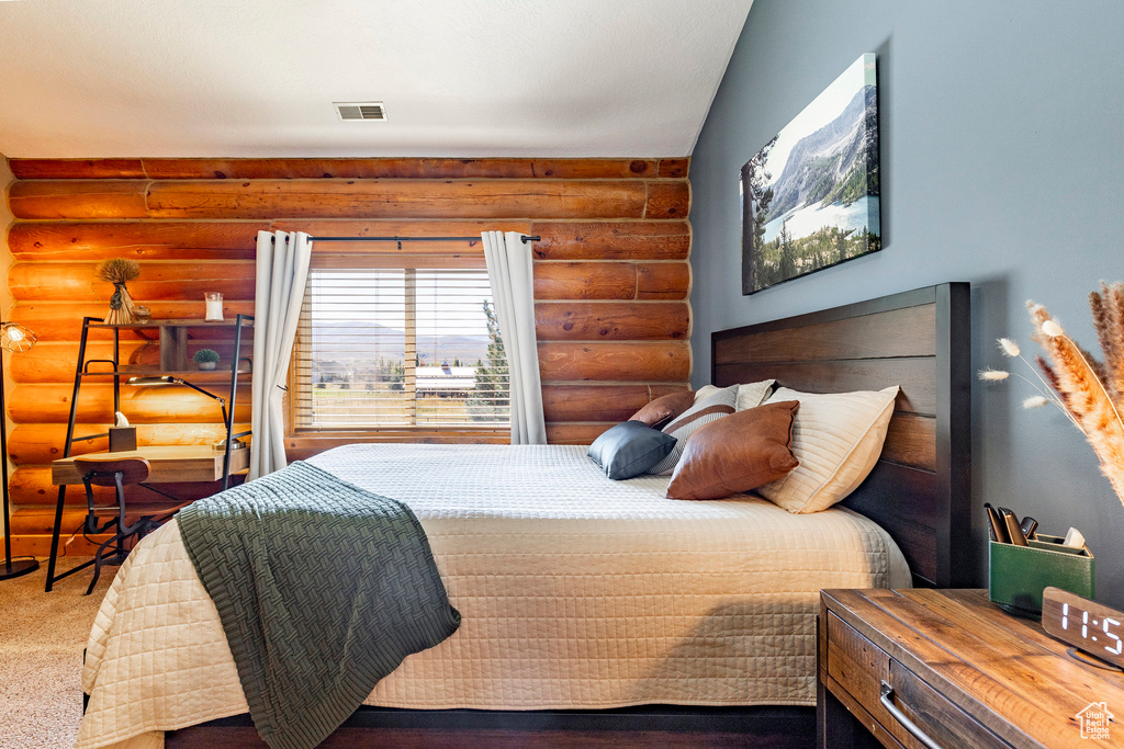 Bedroom featuring rustic walls