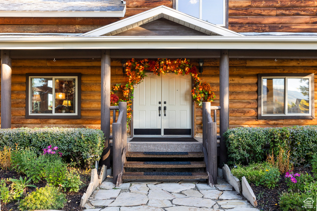 View of exterior entry with a porch