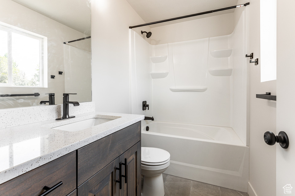 Full bathroom featuring tile patterned flooring, shower / bathing tub combination, toilet, and vanity