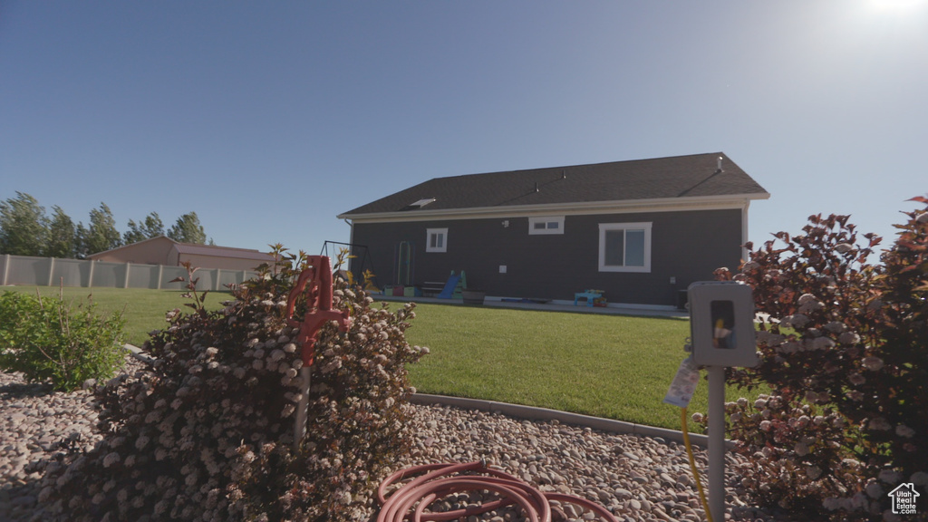 Rear view of house with a yard