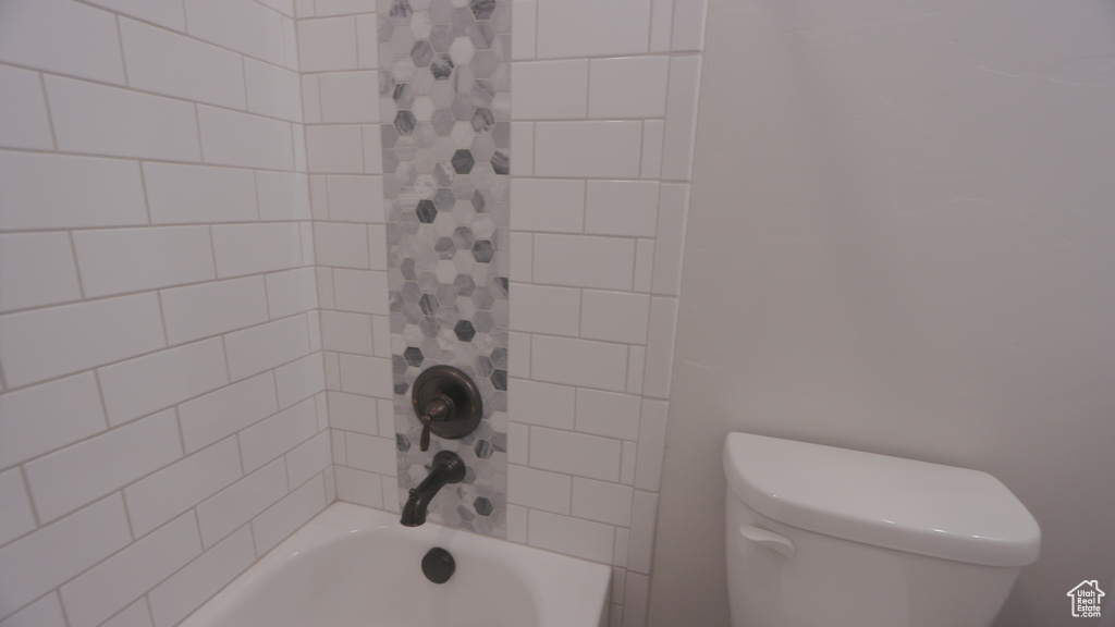 Bathroom with shower / bath combination with curtain and toilet