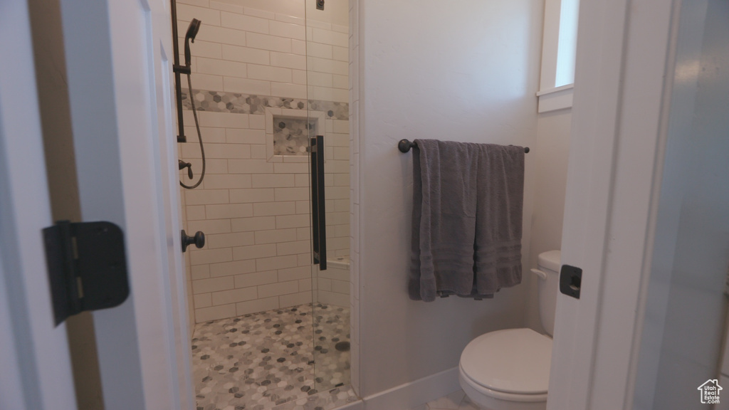 Bathroom with tiled shower and toilet