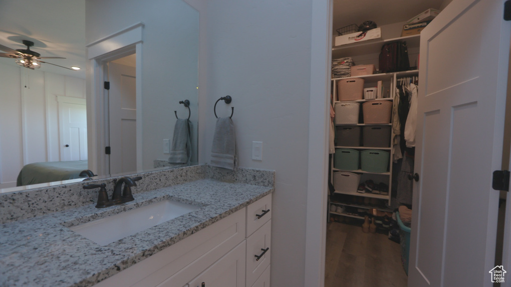 Bathroom with ceiling fan, hardwood / wood-style floors, and vanity