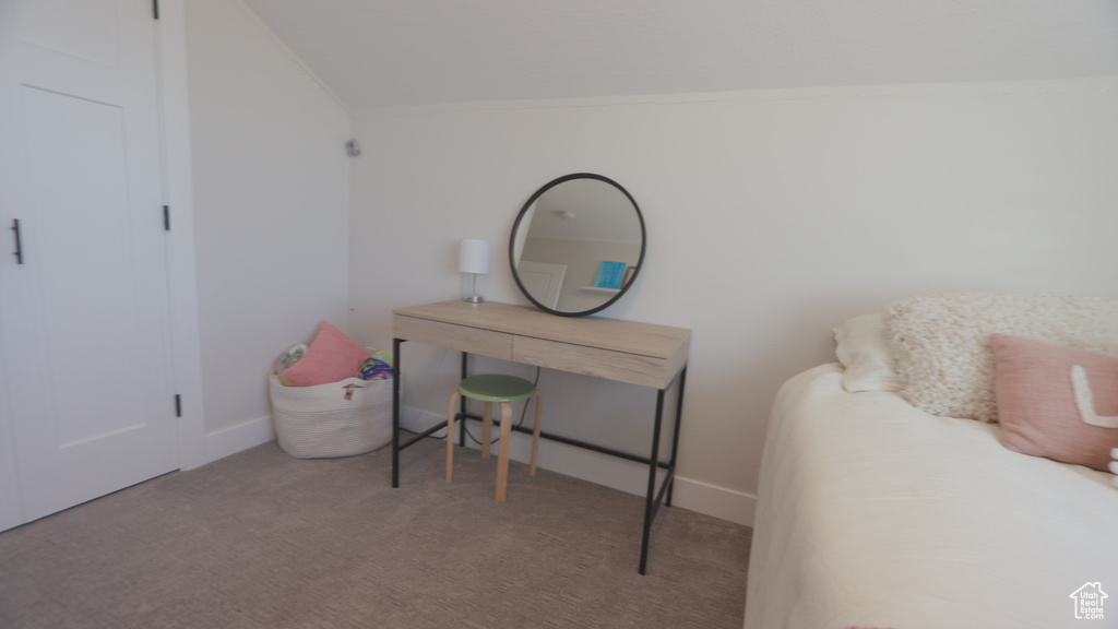 Carpeted home office featuring lofted ceiling