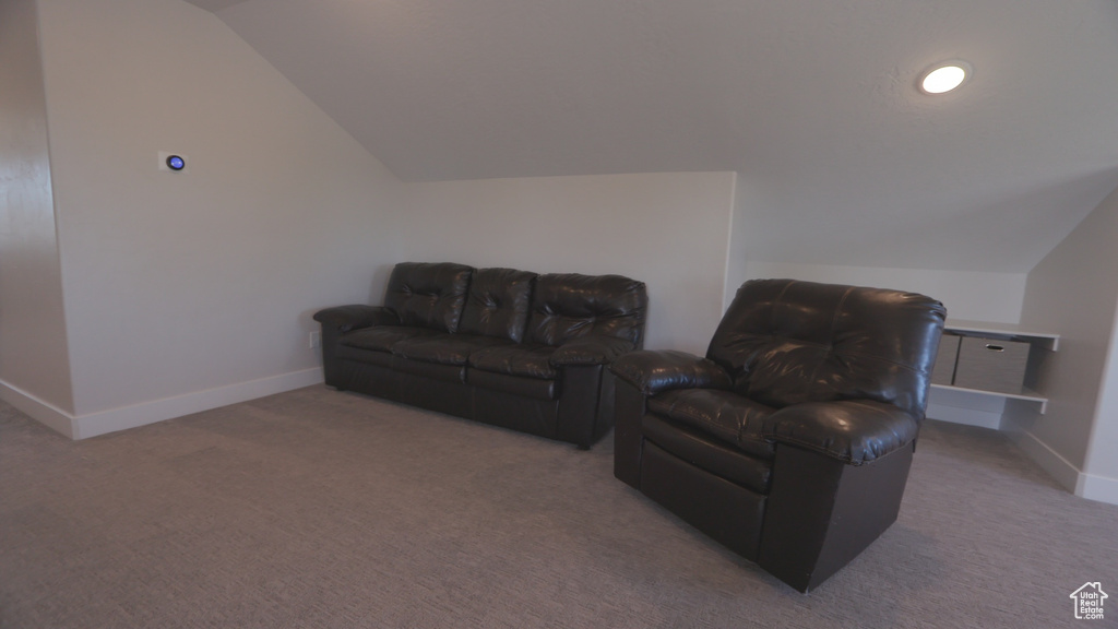 Living room with carpet floors and vaulted ceiling