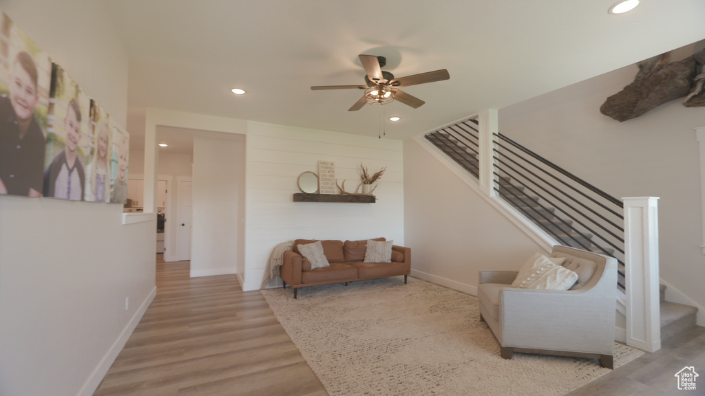 Living room with hardwood / wood-style floors and ceiling fan