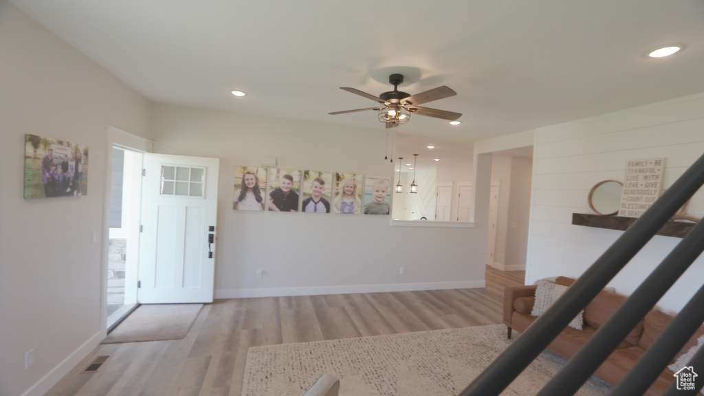 Entryway with hardwood / wood-style floors and ceiling fan