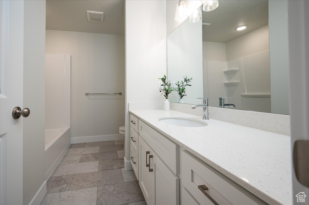 Full bathroom with tile flooring, vanity, toilet, and tub / shower combination