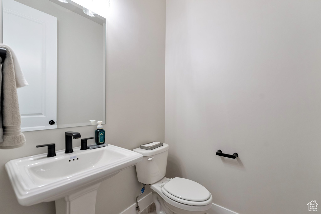 Bathroom featuring sink and toilet