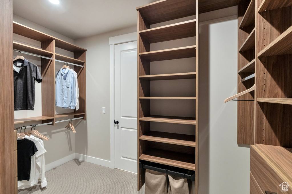 Walk in closet featuring light carpet