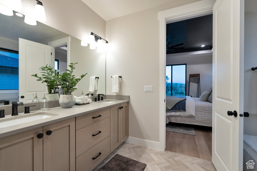 Bathroom featuring hardwood / wood-style floors, large vanity, and double sink