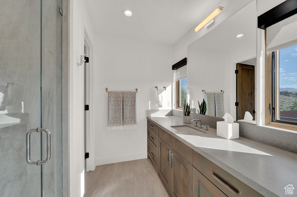 Bathroom featuring a wealth of natural light and vanity