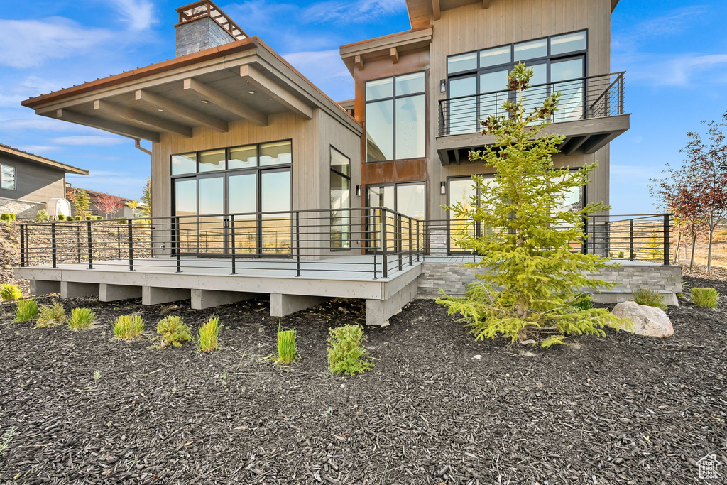 Back of house featuring a balcony