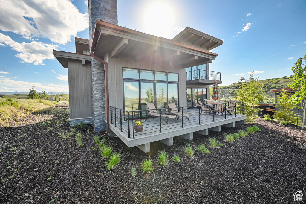 Back of house featuring a wooden deck