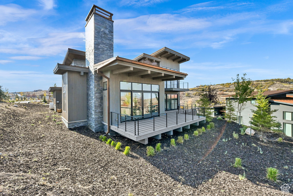 Rear view of house featuring a balcony