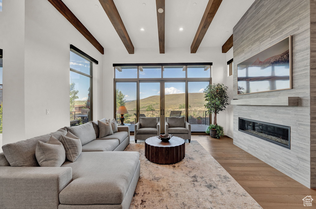 Living room with plenty of natural light and hardwood / wood-style flooring