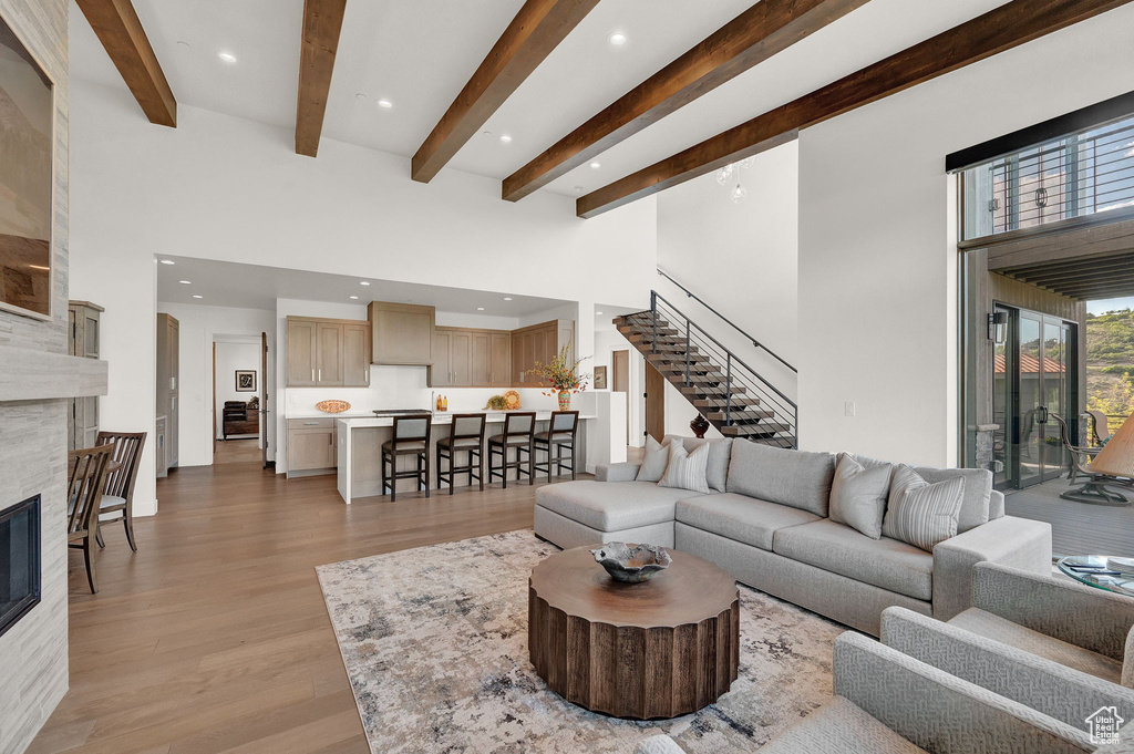 Living room with a fireplace and light wood-type flooring