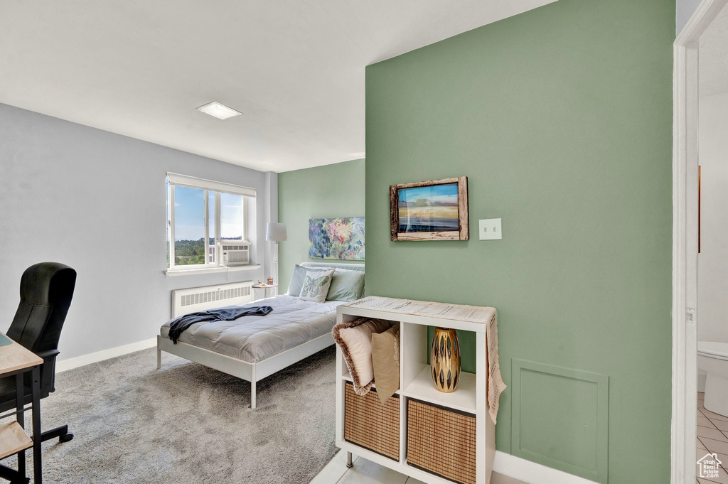 Bedroom featuring cooling unit, carpet flooring, and radiator