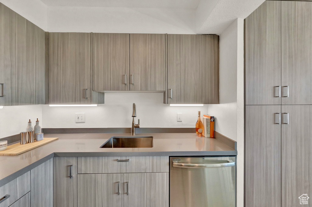 Kitchen featuring sink, dishwasher, and light brown cabinets