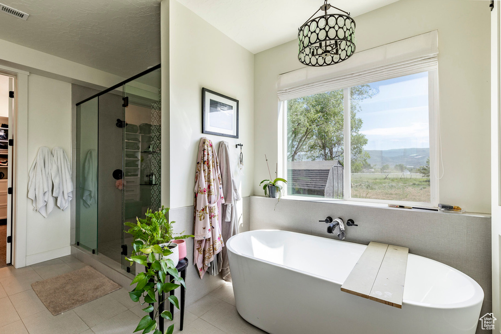 Bathroom featuring tile flooring and separate shower and tub