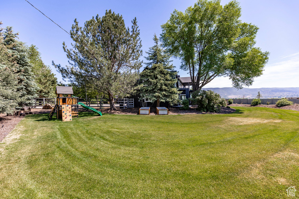 View of yard with a playground and a mountain view