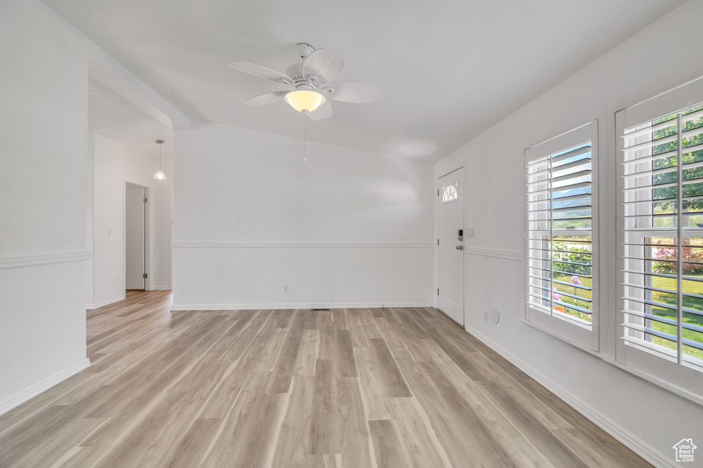 Spare room featuring a healthy amount of sunlight and light hardwood / wood-style floors