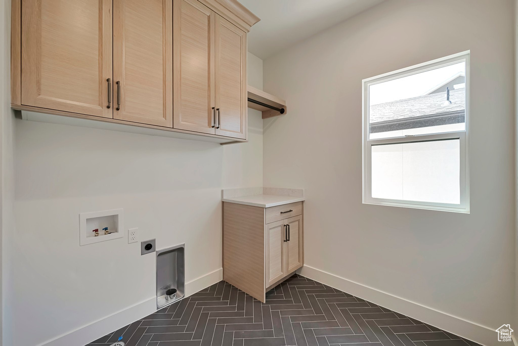 Laundry room with washer hookup, hookup for an electric dryer, and cabinets