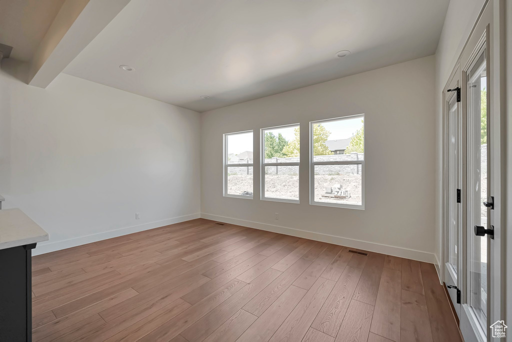 Interior space featuring beamed ceiling and light wood-type flooring