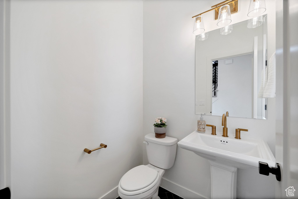 Bathroom with sink, toilet, and tile patterned flooring