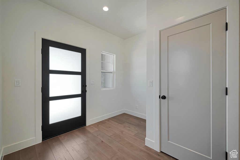 Entrance foyer with hardwood / wood-style flooring