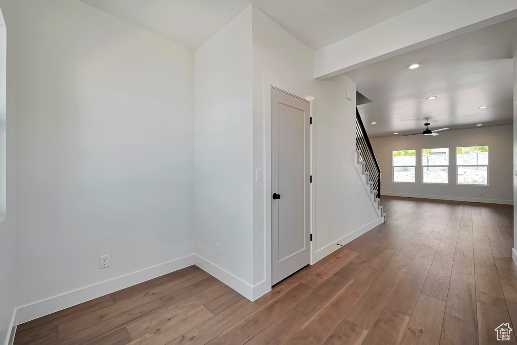 Empty room featuring ceiling fan and hardwood / wood-style floors