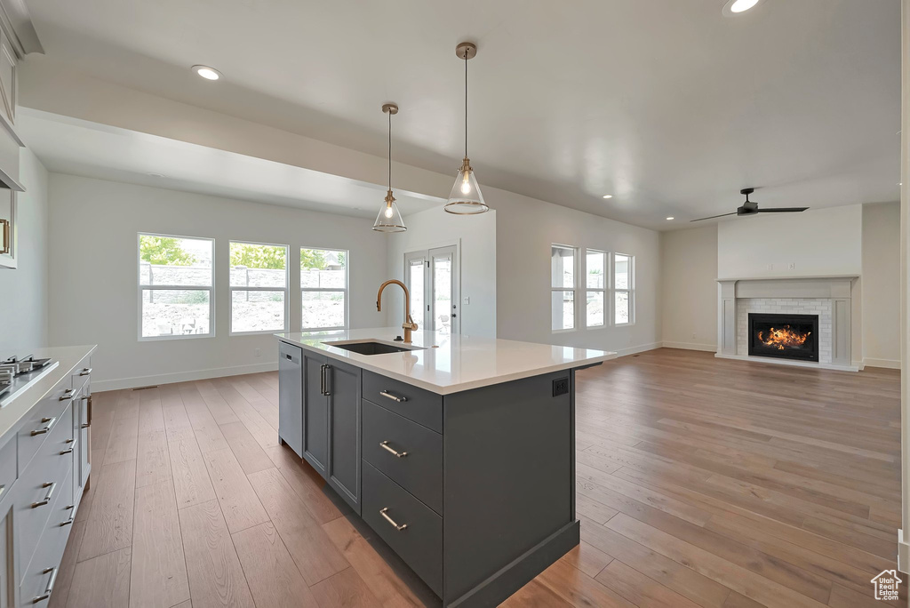 Kitchen featuring a center island with sink, hardwood / wood-style flooring, and a wealth of natural light