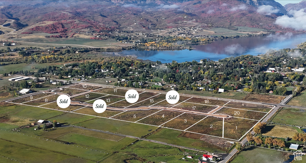 Birds eye view of property with a water view