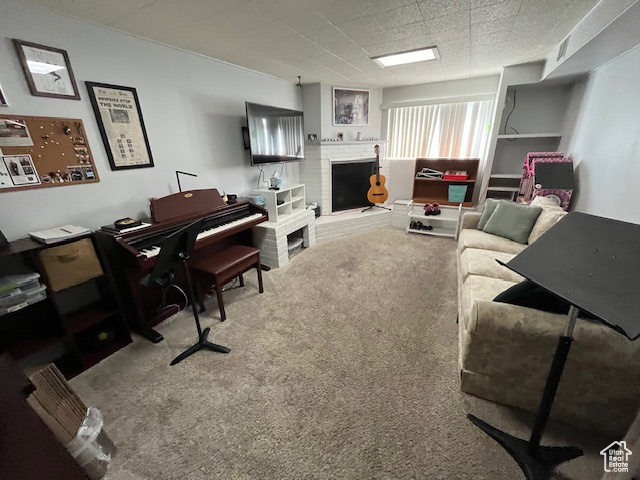 Carpeted living room with a brick fireplace