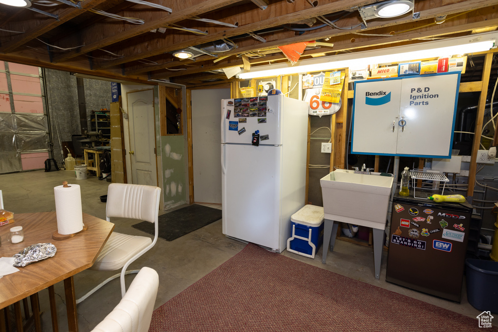 Basement featuring white refrigerator