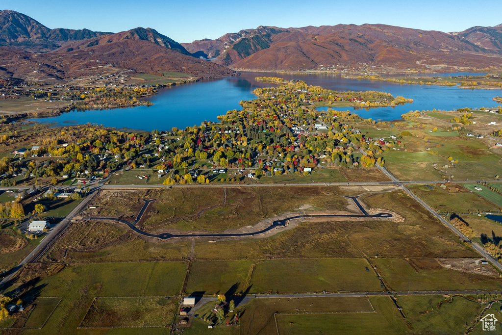 Birds eye view of property with a water and mountain view